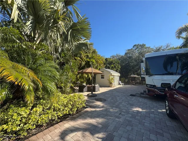 a swimming pool with outdoor seating and yard