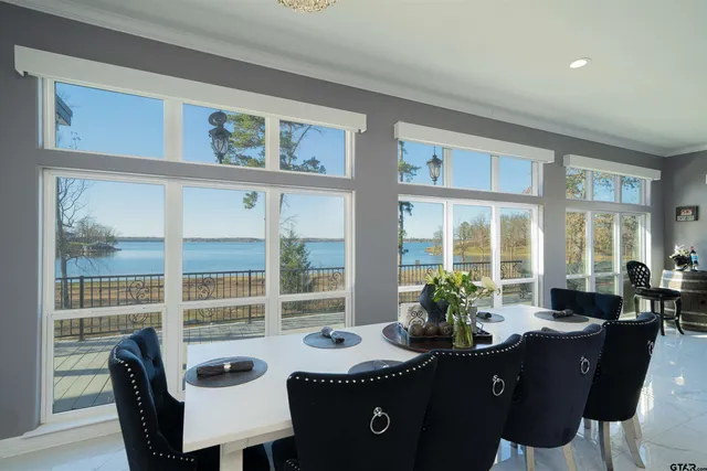 a view of a dining room with furniture large windows and wooden floor