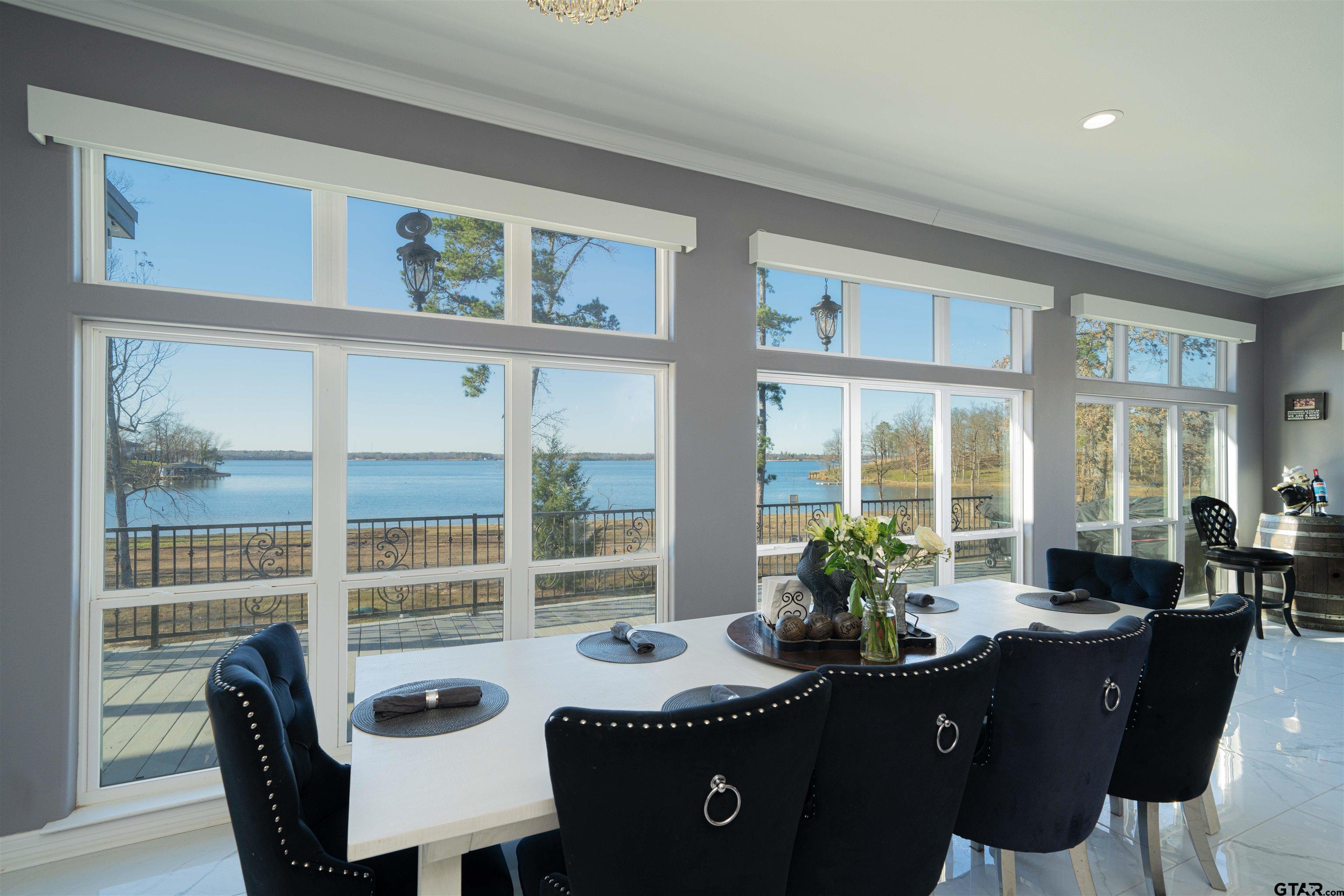 145 Private Road Pittsburg, TX 75686 - Photo 12 of 46 a view of a dining room with furniture large windows and wooden floor
