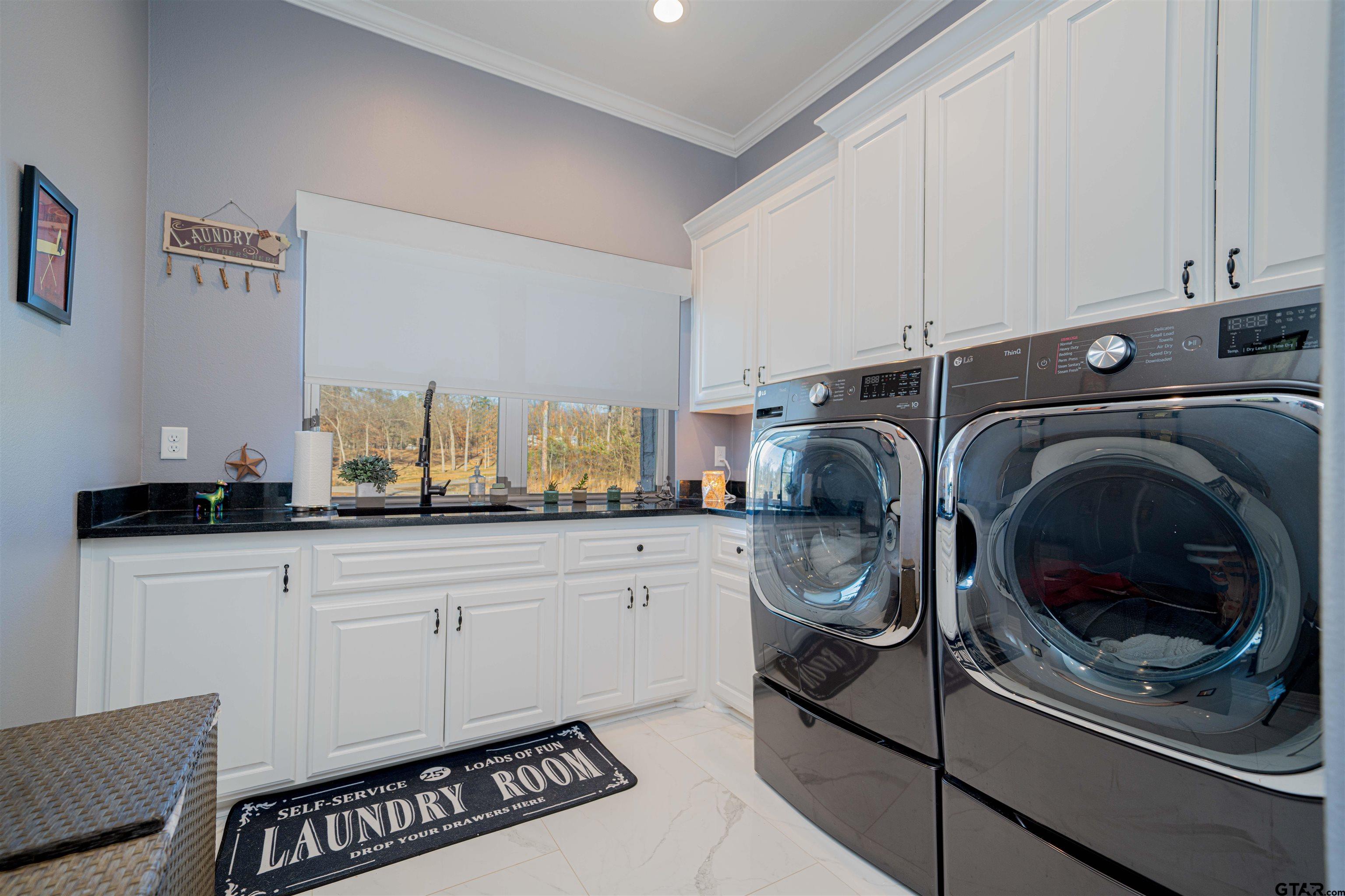 145 Private Road Pittsburg, TX 75686 - Photo 15 of 46 a utility room with sink dryer and washer
