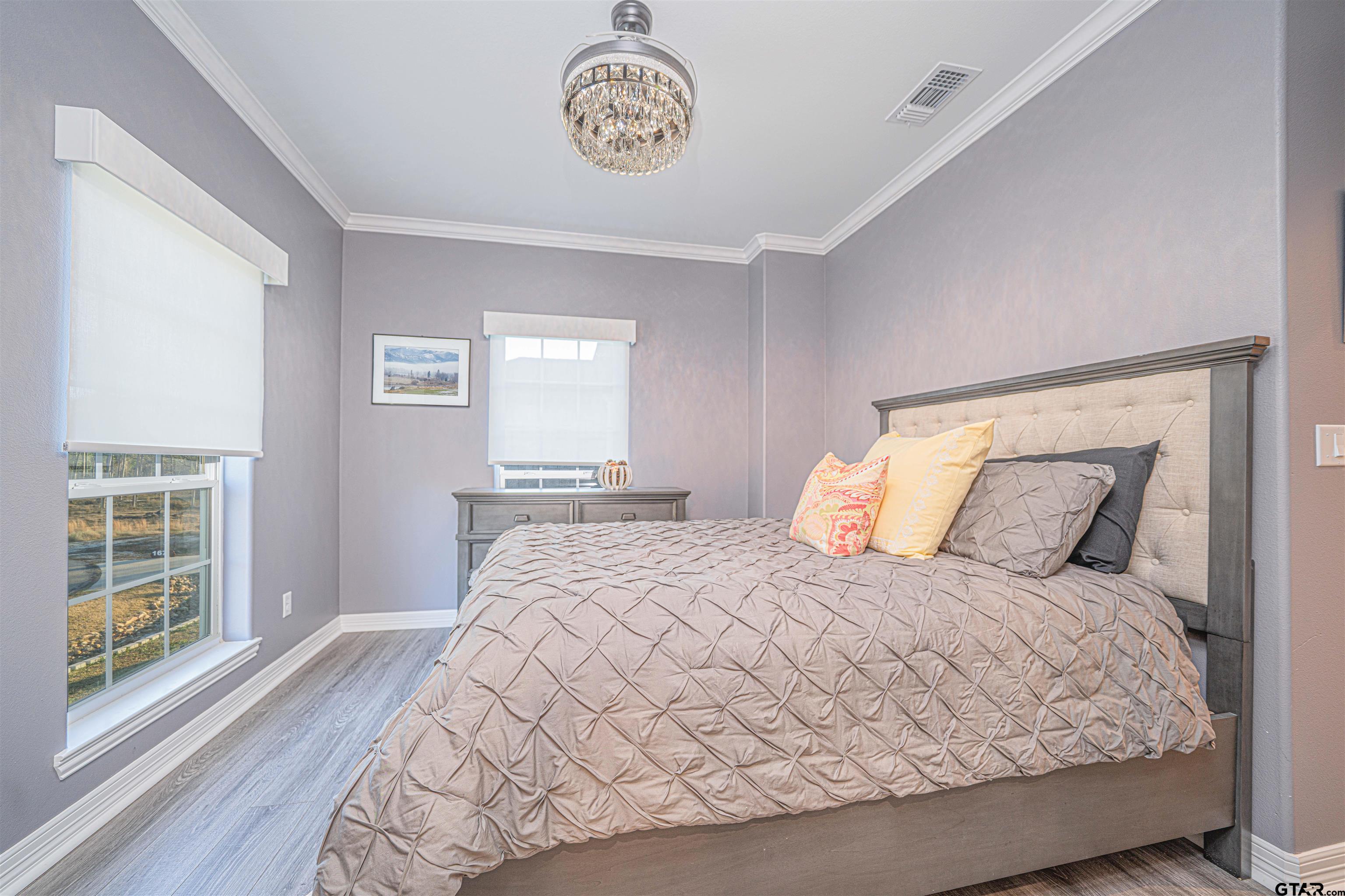 145 Private Road Pittsburg, TX 75686 - Photo 22 of 46 a bedroom with a large bed and a window