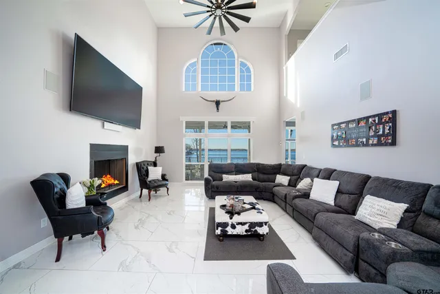 a living room with furniture a flat screen tv and a fireplace
