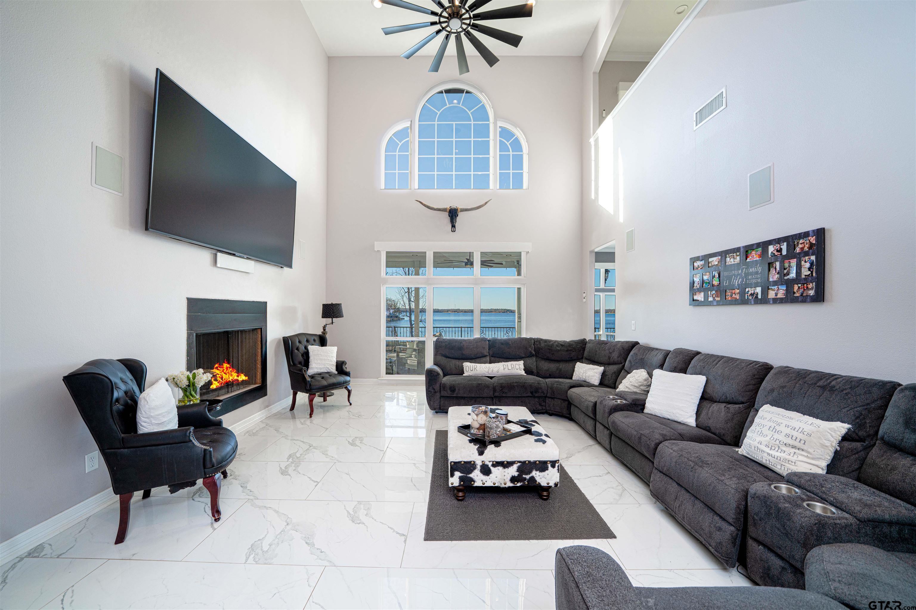 145 Private Road Pittsburg, TX 75686 - Photo 6 of 46 a living room with furniture a flat screen tv and a fireplace