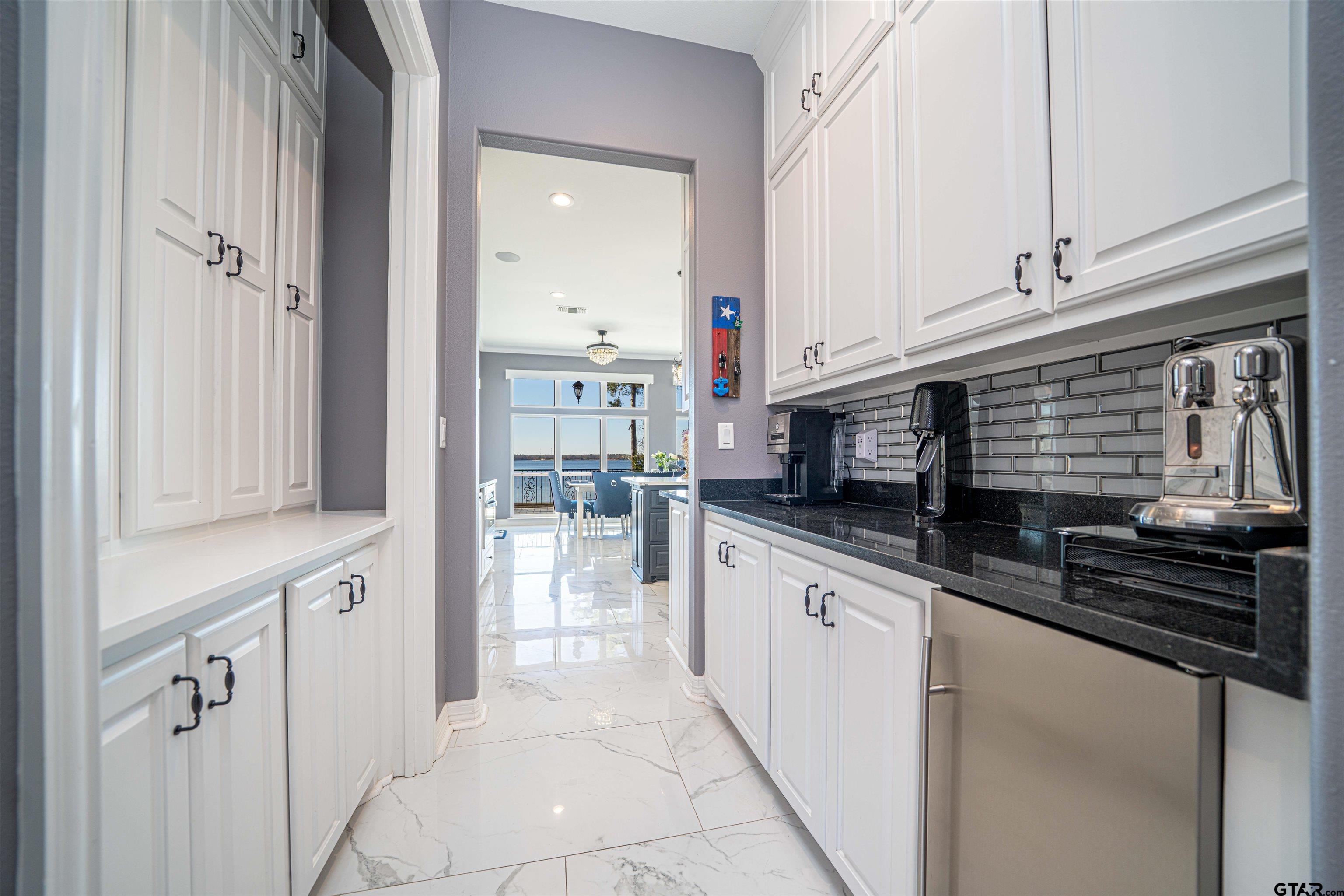 145 Private Road Pittsburg, TX 75686 - Photo 7 of 46 a kitchen with stainless steel appliances granite countertop a sink and a stove