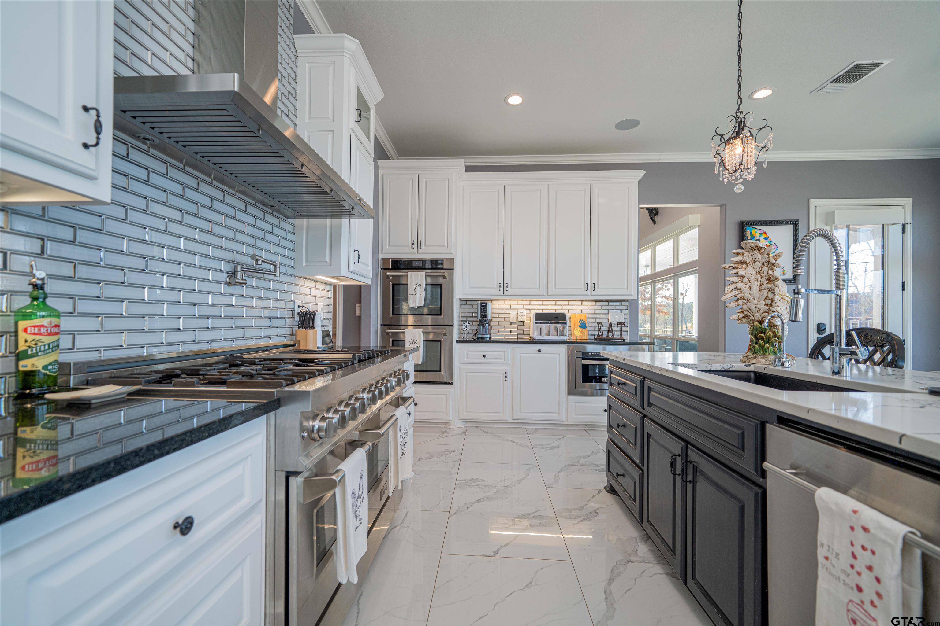 145 Private Road Pittsburg, TX 75686 - Photo 9 of 46 a kitchen with stainless steel appliances granite countertop a stove and a sink