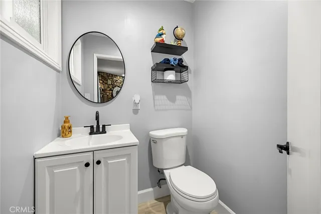 a bathroom with a toilet a sink and a mirror