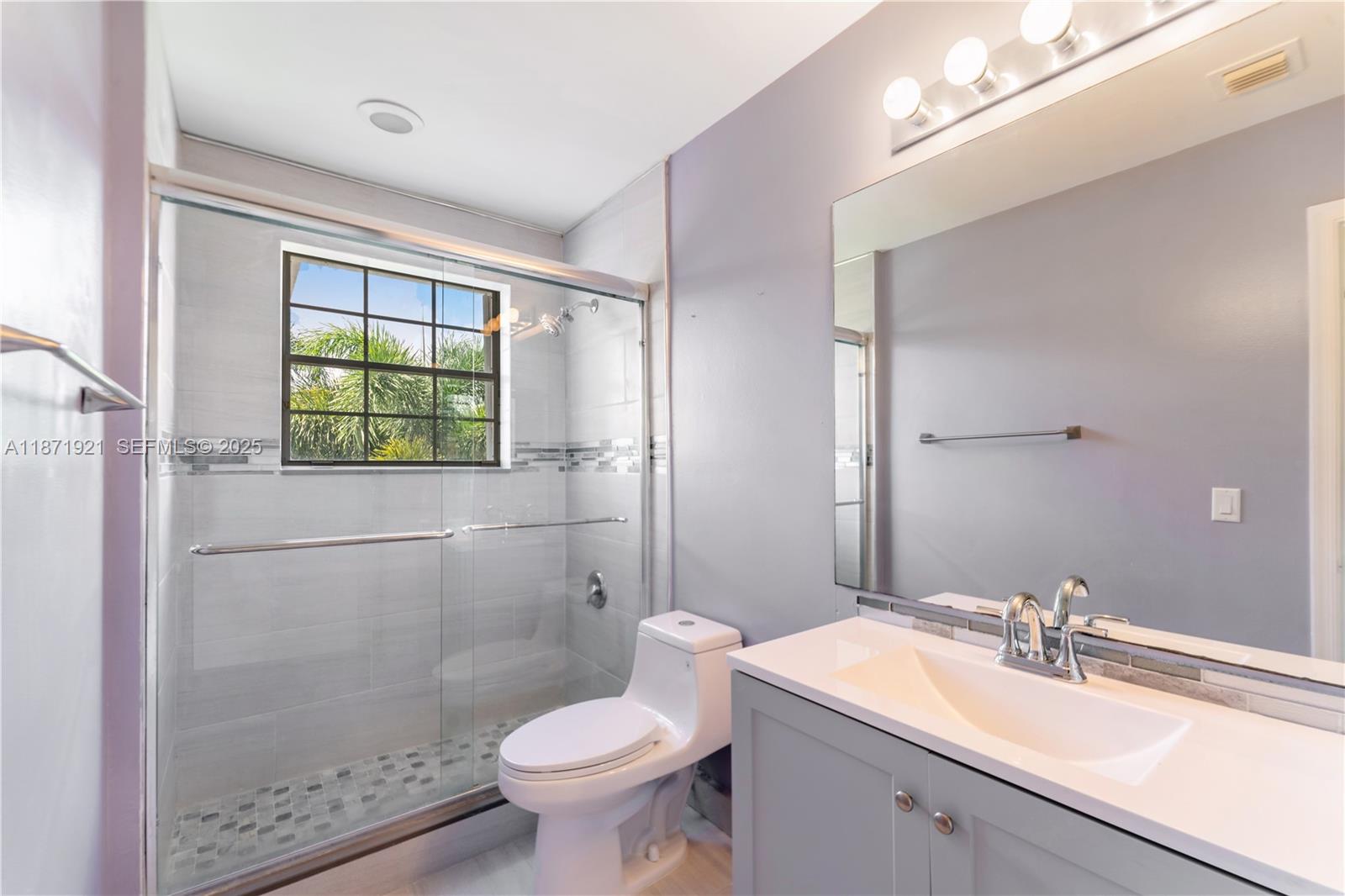 1943 Southwest 149th Avenue Miramar, FL 33027 - Photo 11 of 26 a bathroom with a sink toilet a mirror and shower