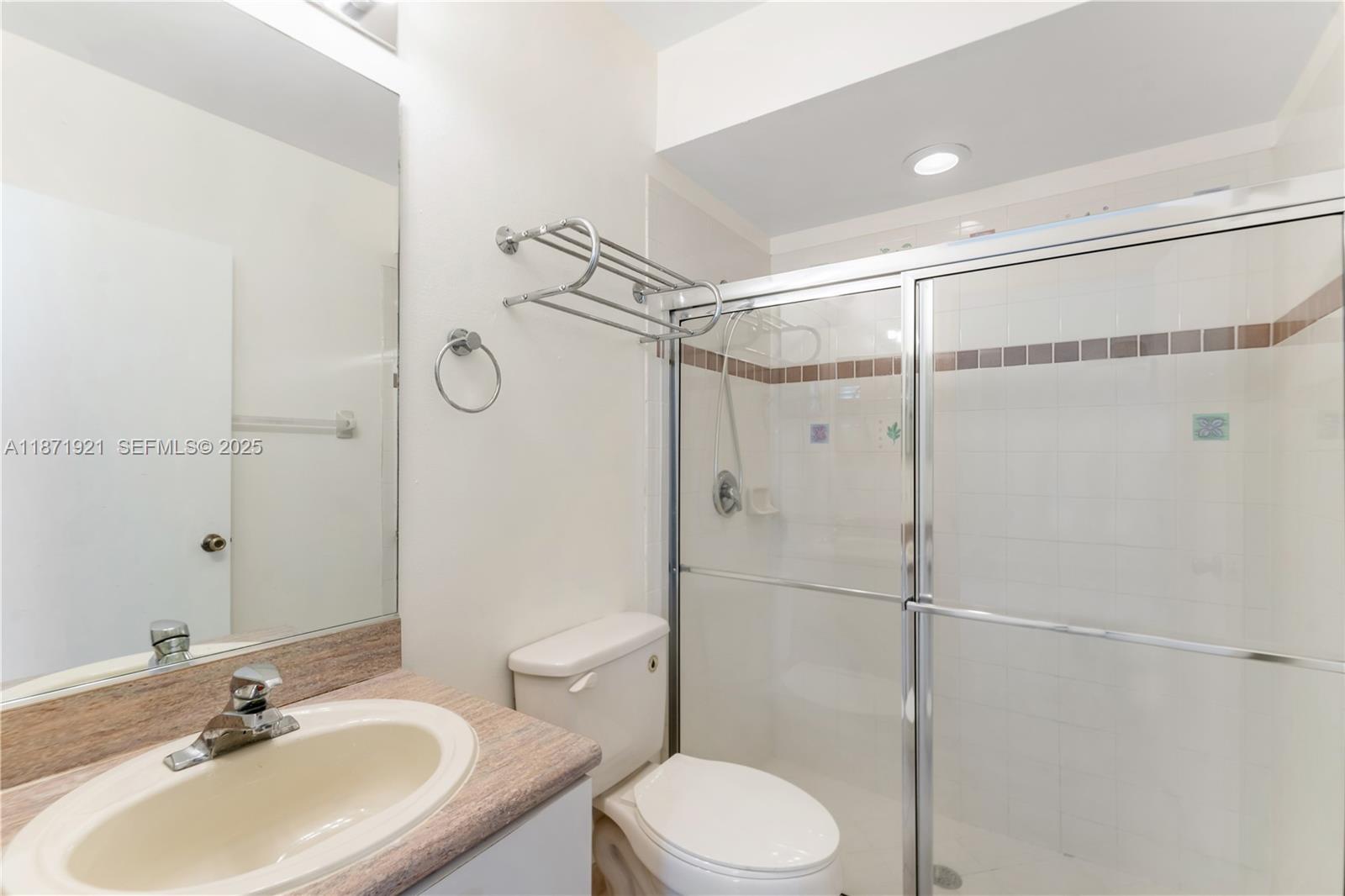 1943 Southwest 149th Avenue Miramar, FL 33027 - Photo 13 of 26 a bathroom with a sink toilet and shower