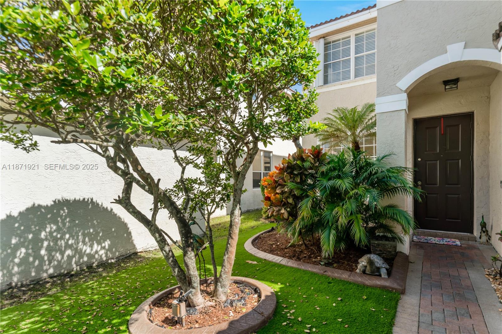 1943 Southwest 149th Avenue Miramar, FL 33027 - Photo 21 of 26 a front view of a house with garden