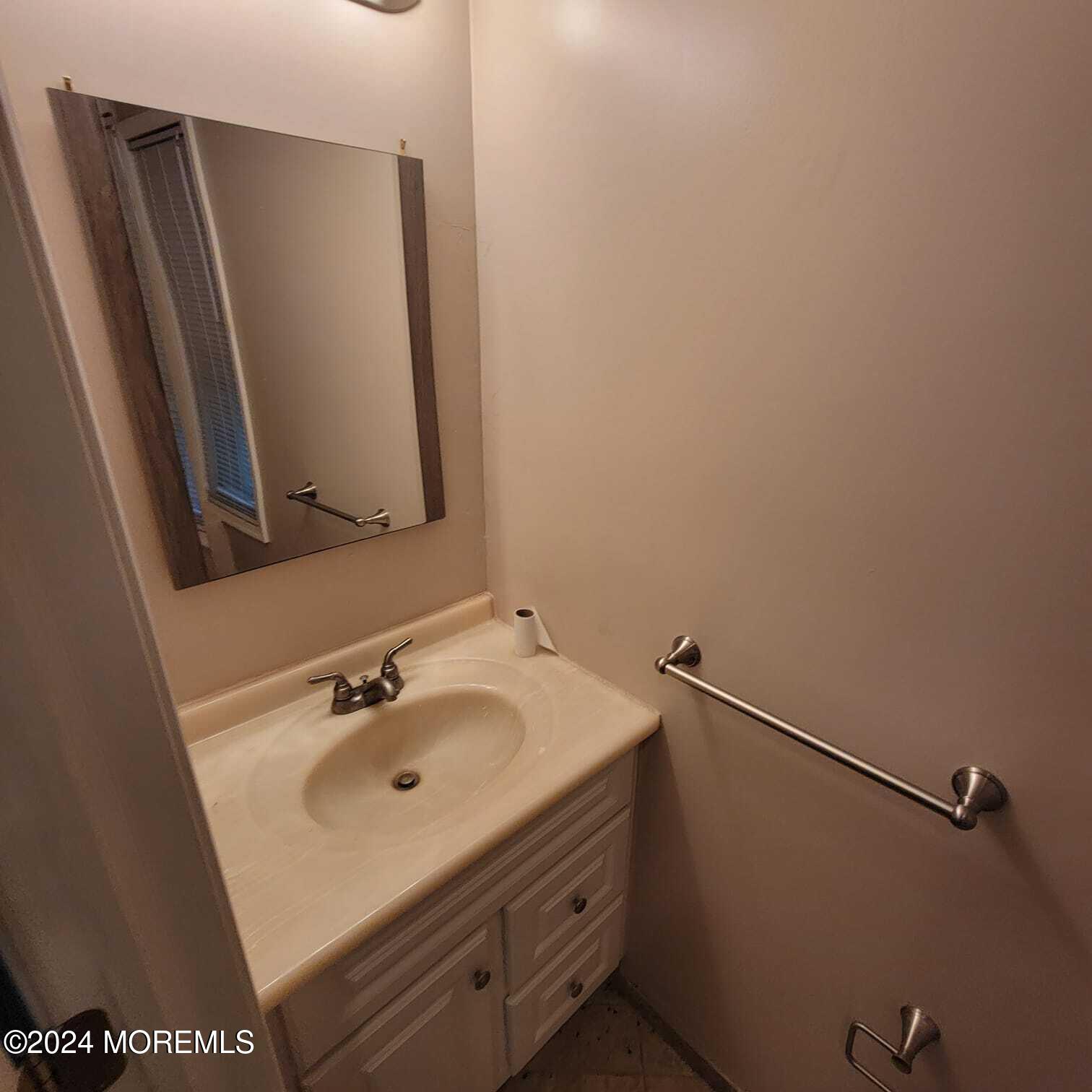 63 Reids Hill Road Morganville, NJ 07751 - Photo 11 of 32 a bathroom with a sink and mirror