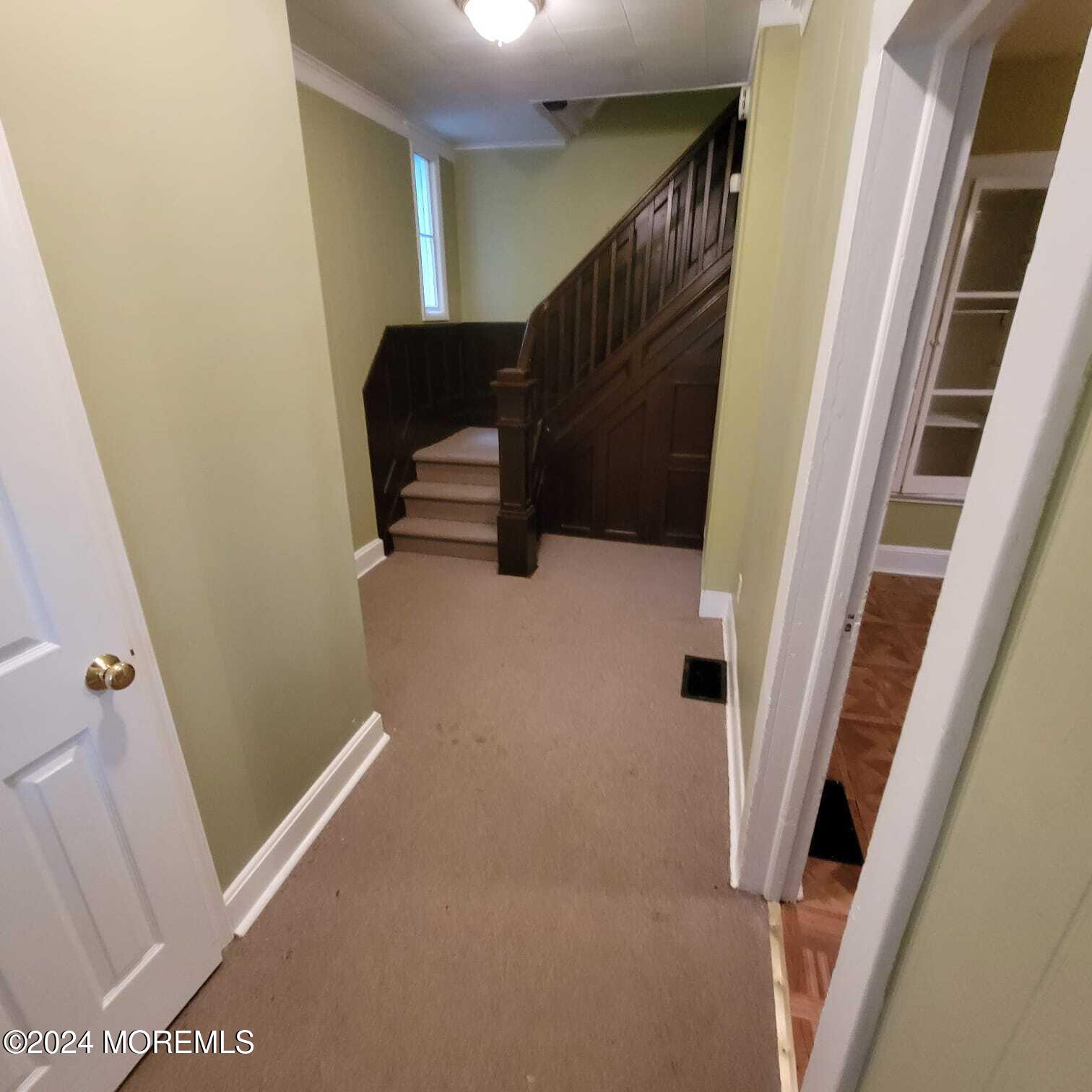 63 Reids Hill Road Morganville, NJ 07751 - Photo 12 of 32 a view of staircase with wooden floor and chair