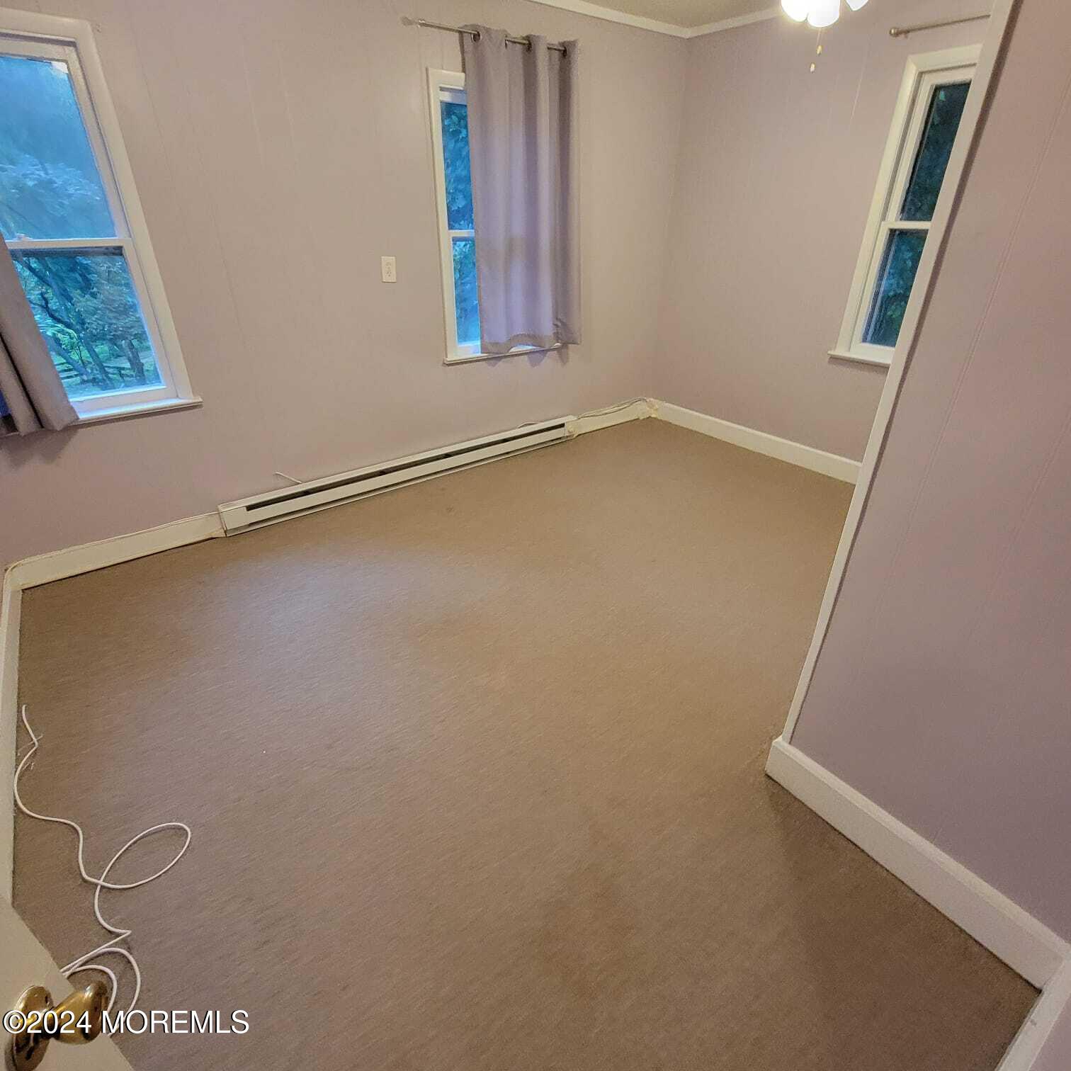 63 Reids Hill Road Morganville, NJ 07751 - Photo 15 of 32 a view of a room with rack on the wall and a window