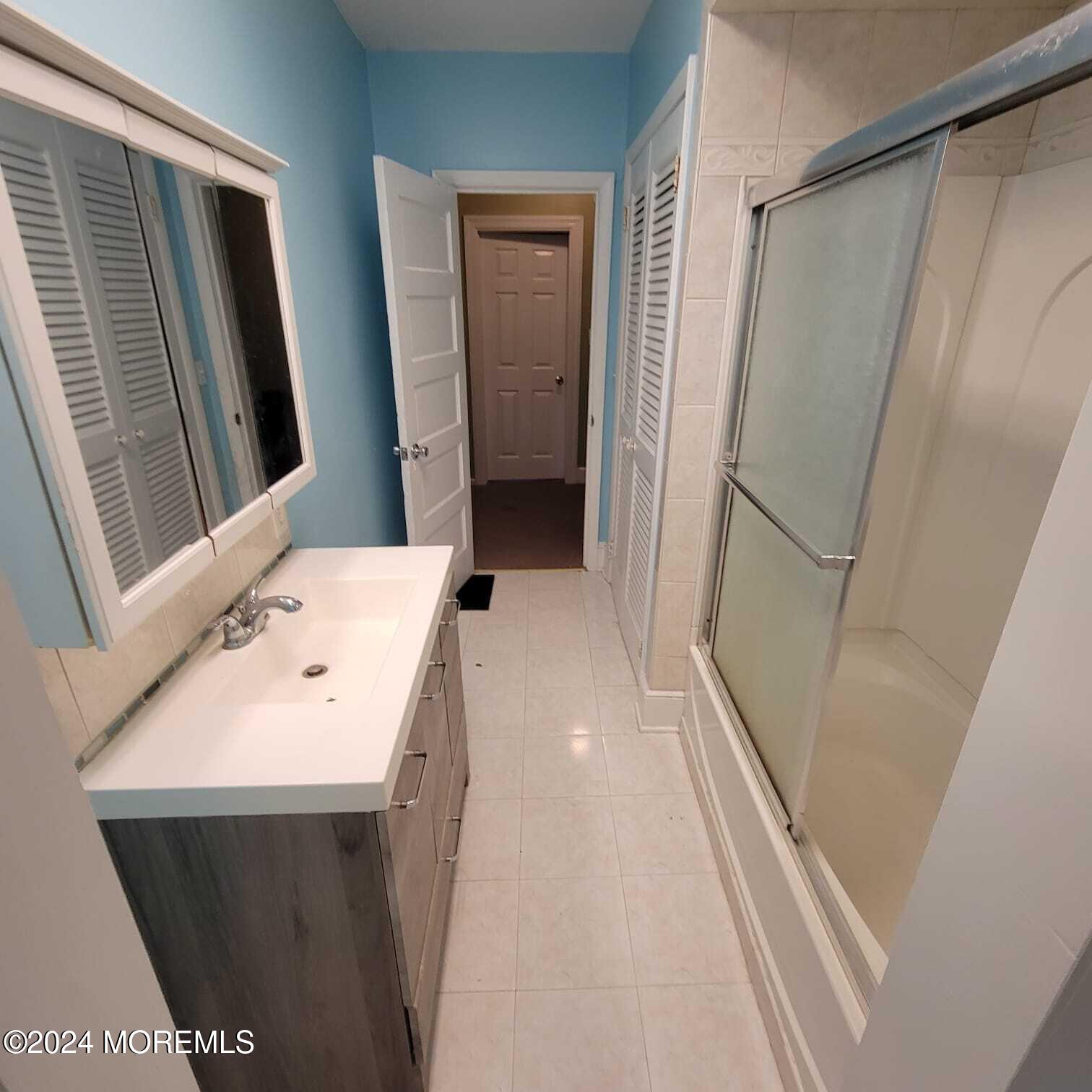 63 Reids Hill Road Morganville, NJ 07751 - Photo 21 of 32 a bathroom with a sink a toilet and a mirror