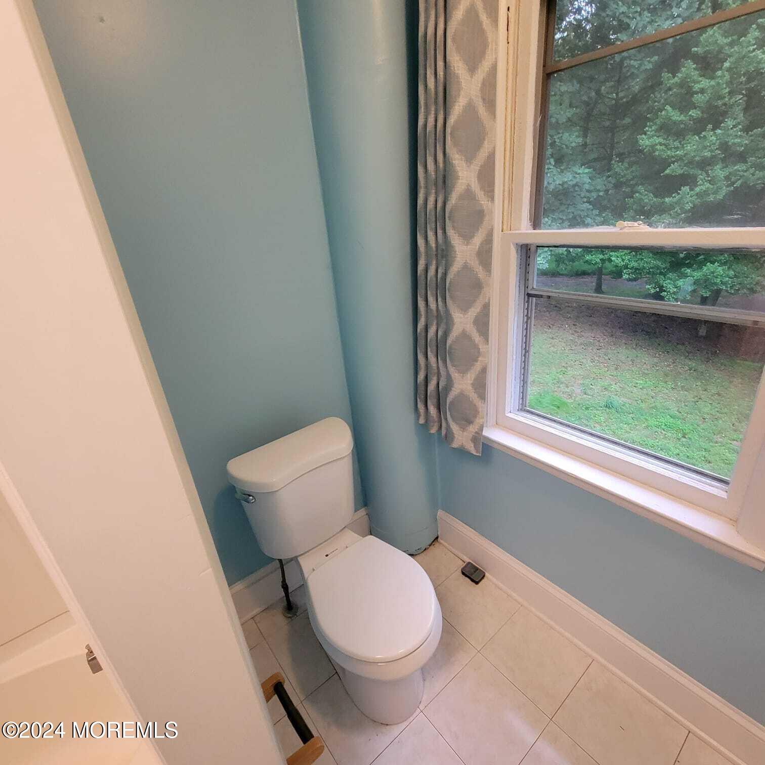 63 Reids Hill Road Morganville, NJ 07751 - Photo 23 of 32 a white toilet sitting next to a window