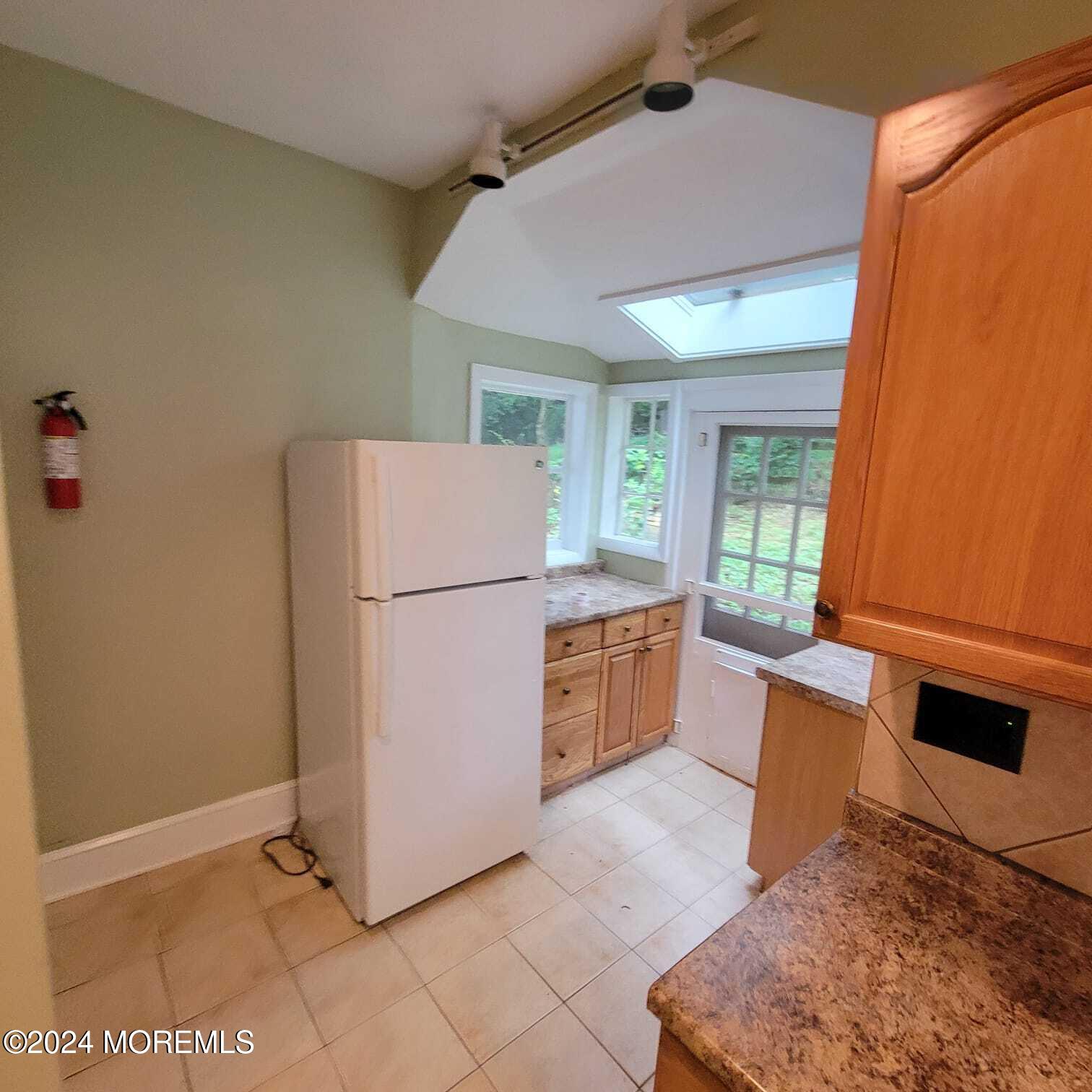 63 Reids Hill Road Morganville, NJ 07751 - Photo 6 of 32 a kitchen with sink a refrigerator and a stove