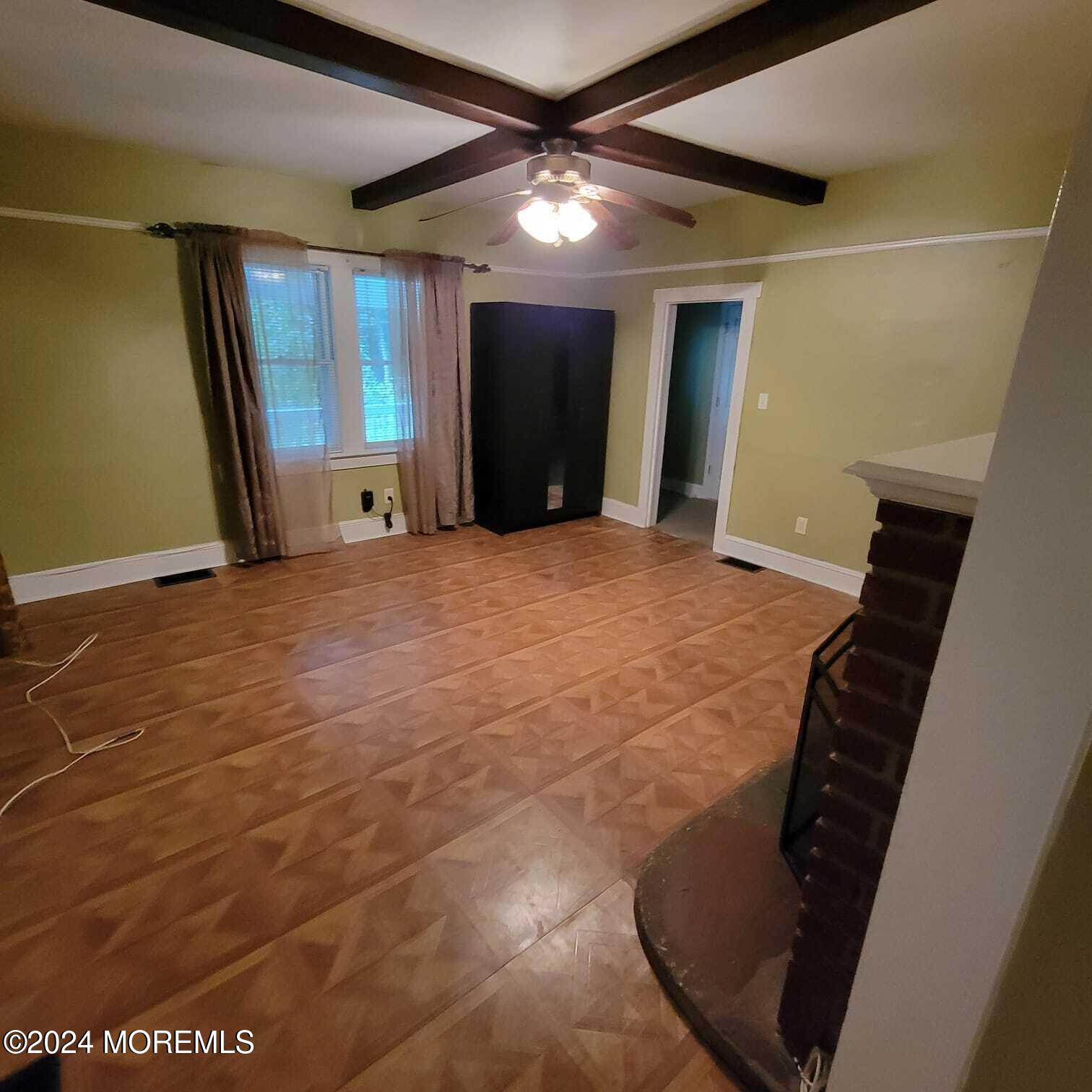 63 Reids Hill Road Morganville, NJ 07751 - Photo 9 of 32 a view of an empty room with wooden floor and a window