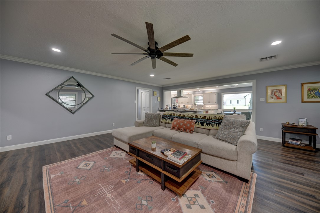 1600 Pecan Street Brenham, TX 77833 - Photo 9 of 33 Living room featuring ceiling fan, crown molding, baseboards, and recessed lighting