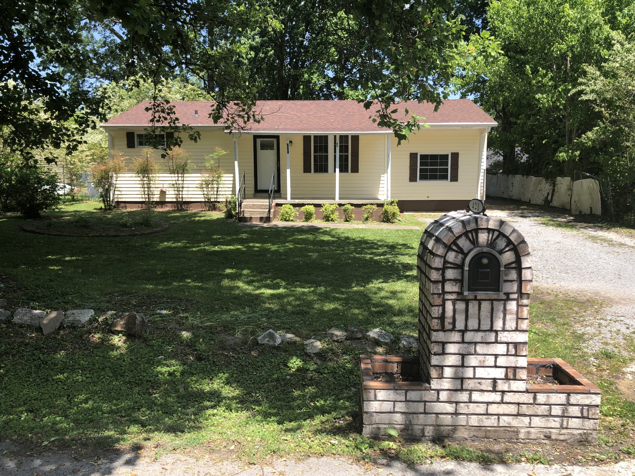 421 Oakwood Road Tullahoma, TN 37388 - Photo 1 of 13 a front view of a house with a garden