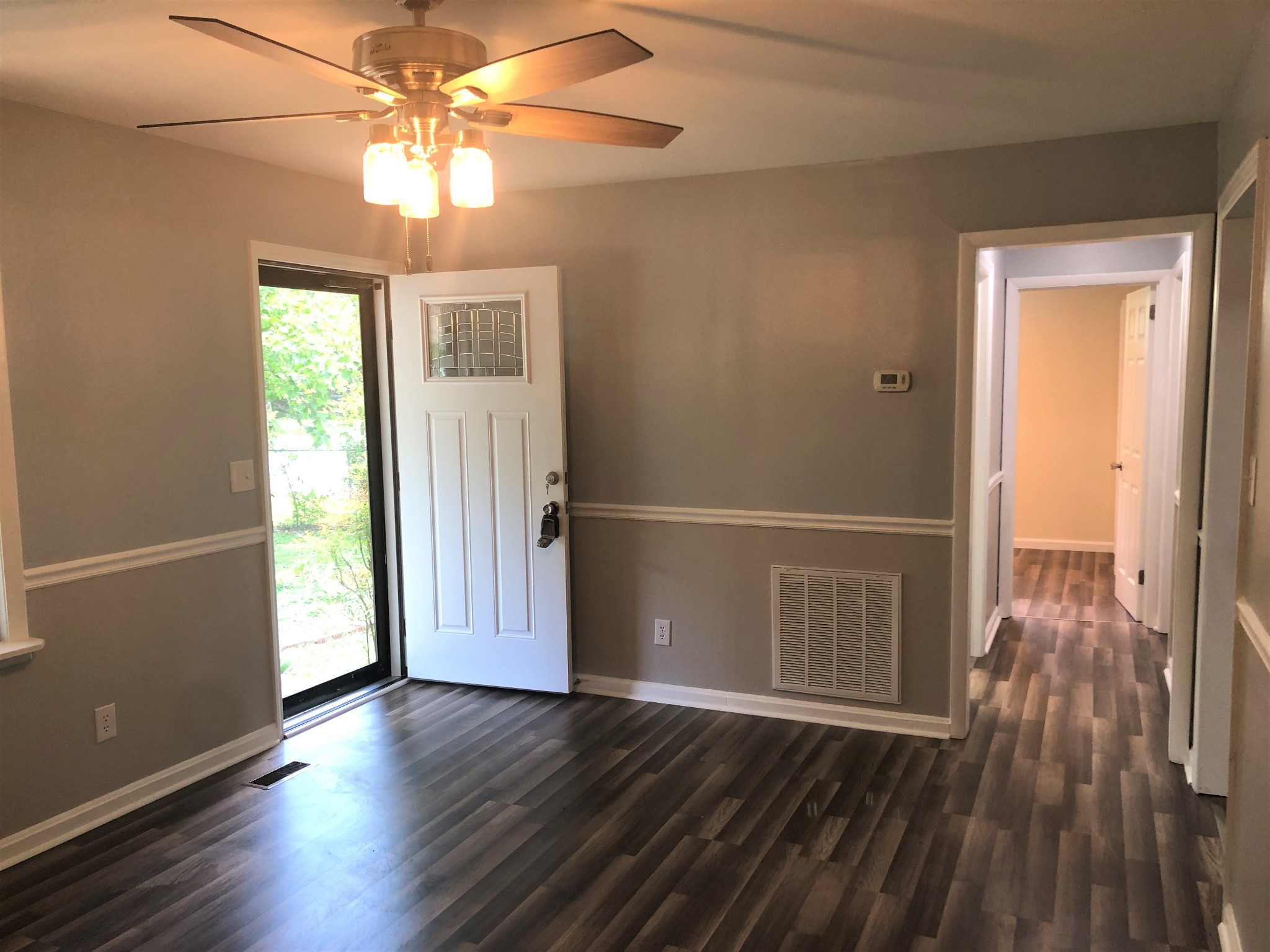 421 Oakwood Road Tullahoma, TN 37388 - Photo 5 of 13 an empty room with wooden floor fan and windows