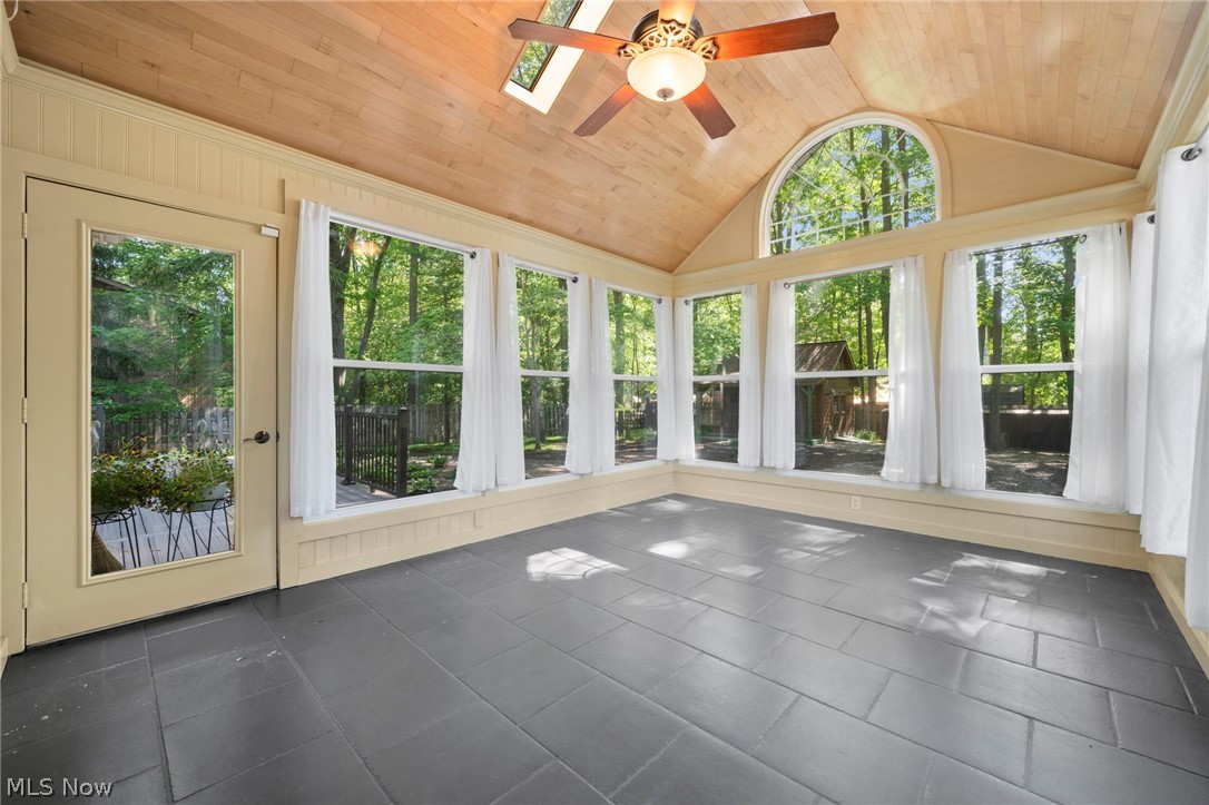 3871 Greentree Road Stow, OH 44224 - Photo 16 of 50 Sunroom with vaulted wood-plank ceiling, skylight, and ceiling fan