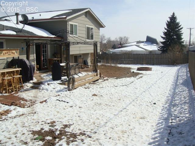 2328 Monterey Road Colorado Springs, CO 80910 - Photo 19 of 20 Huge backyard with a bricked in fire pit. Enjoy those s'mors!