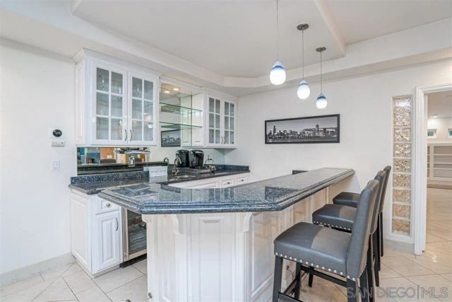 a kitchen with stainless steel appliances granite countertop a stove a sink a dining table and chairs