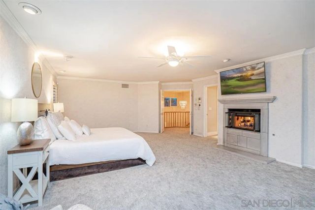 a spacious bedroom with a bed and a fireplace