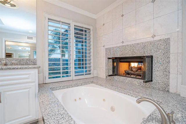 a bathroom with a fireplace and a tub
