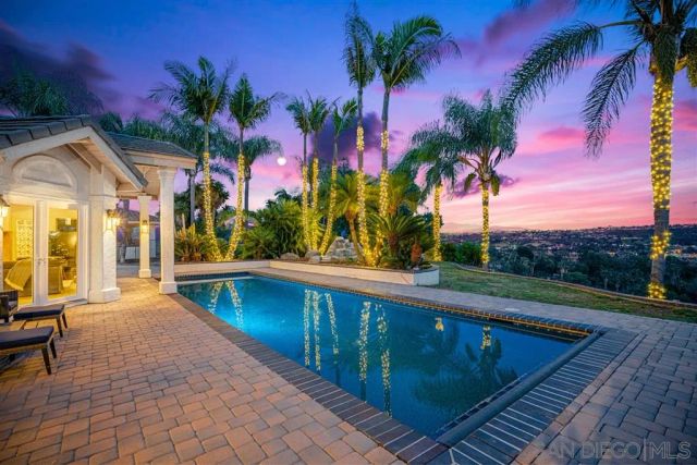 a view of swimming pool with a table and chairs