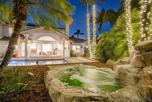 a swimming pool with outdoor seating and yard