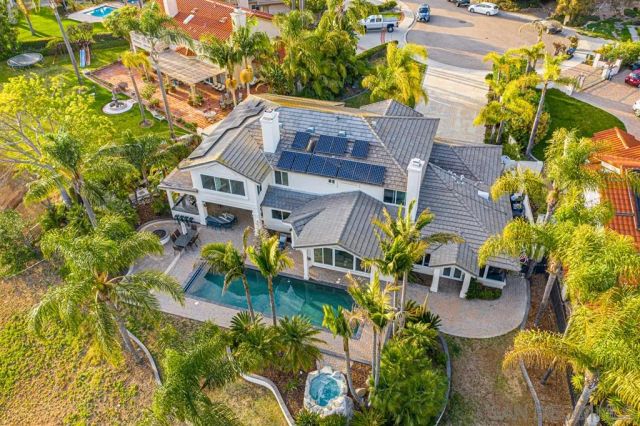 an aerial view of a house with a yard and garden