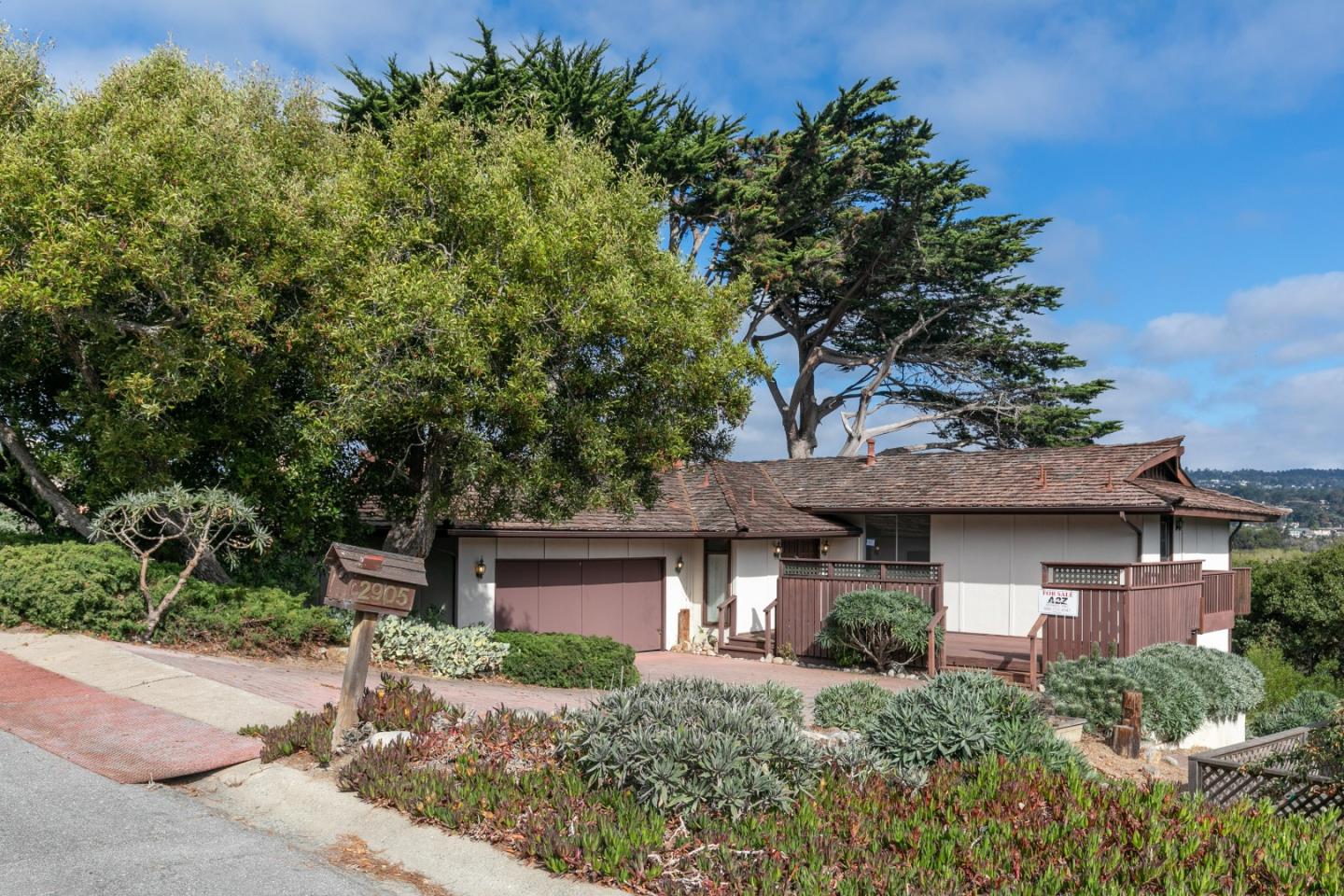 2905 Ribera Road Carmel, CA 93923 - Photo 34 of 47 front view of a house with a tree