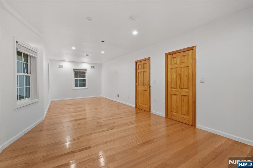 81 Fairmount Avenue Hackensack, NJ 07601 - Photo 16 of 19 a view of an empty room with wooden floor and windows