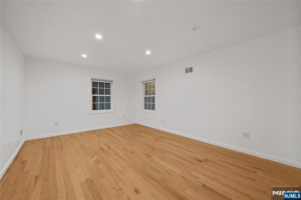 81 Fairmount Avenue Hackensack, NJ 07601 - Photo 17 of 19 a view of empty room with wooden floor and fan