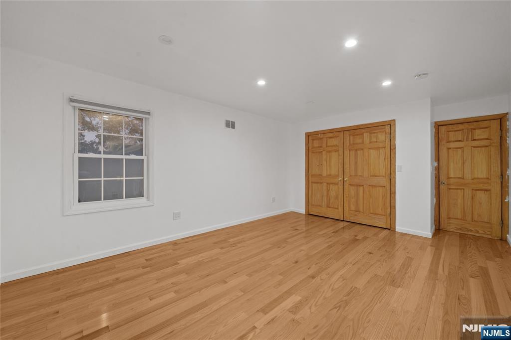 81 Fairmount Avenue Hackensack, NJ 07601 - Photo 18 of 19 an empty room with wooden floor and windows