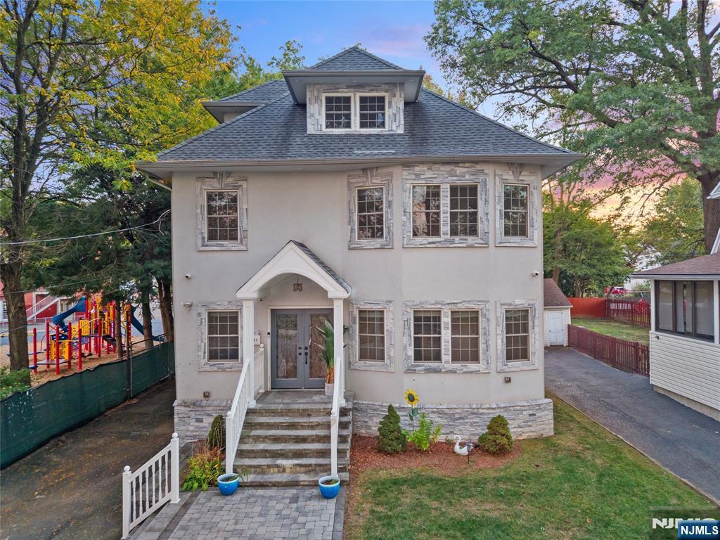81 Fairmount Avenue Hackensack, NJ 07601 - Photo 3 of 19 a front view of a house with a yard