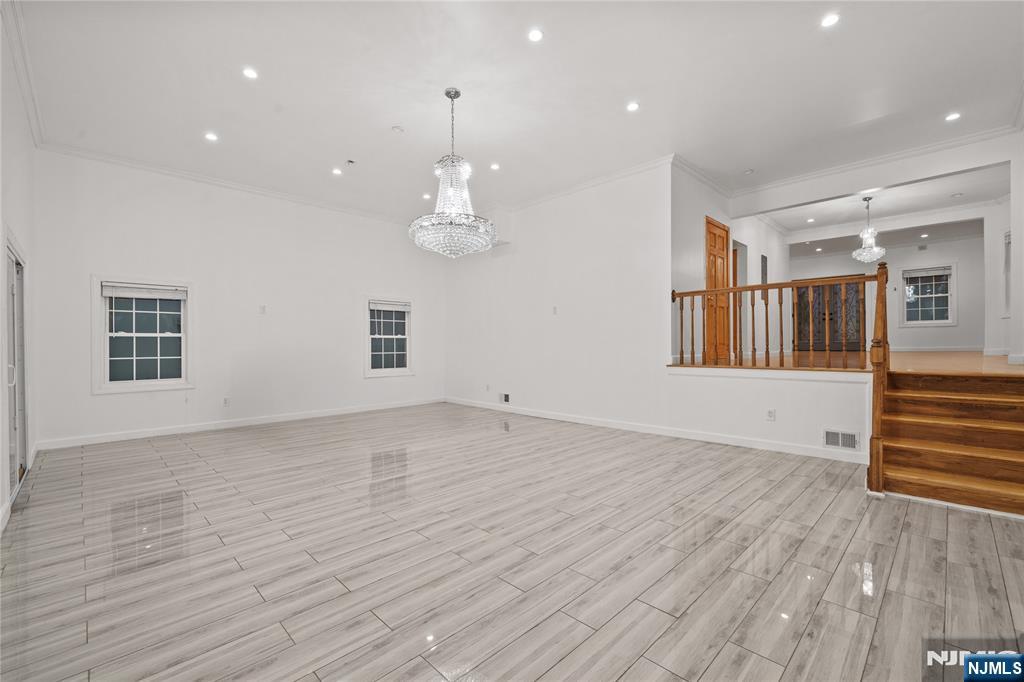 81 Fairmount Avenue Hackensack, NJ 07601 - Photo 7 of 19 a view of an empty room with wooden floor and a window