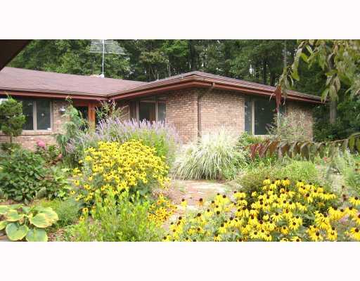 Exterior Front. All brick ranch that shows the stone walkway and the beautiful perennial garden