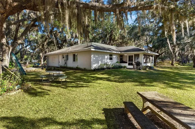a view of a house with garden and sitting area