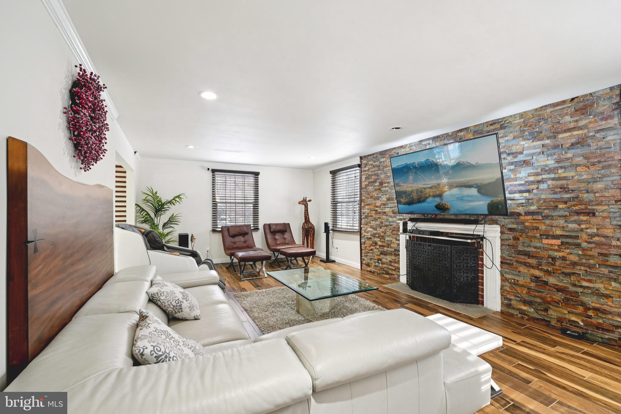 700 Campwoods Road Villanova, PA 19085 - Photo 15 of 72 a living room with furniture a flat screen tv and a fireplace