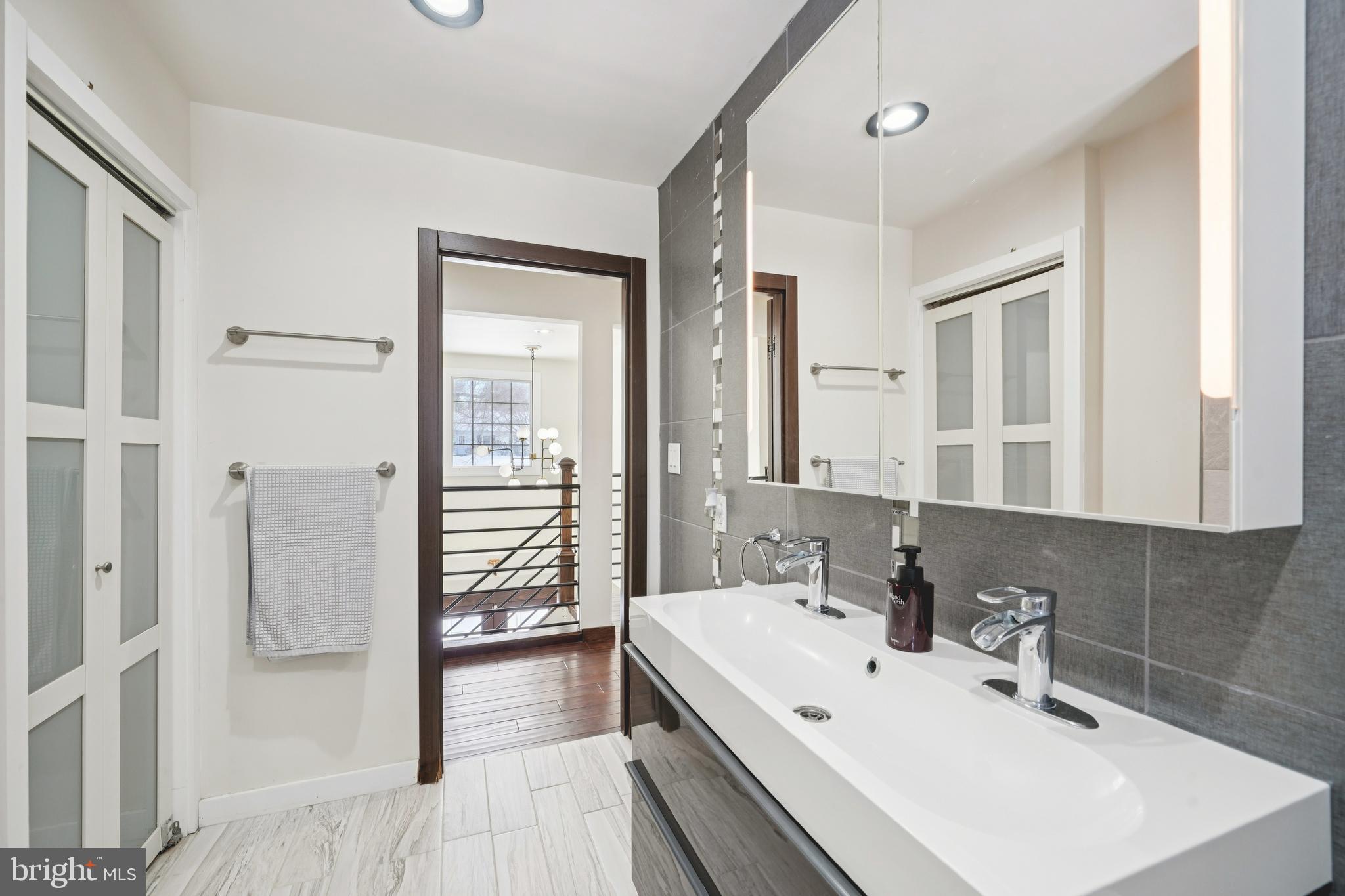 700 Campwoods Road Villanova, PA 19085 - Photo 35 of 72 a view of a bathroom with a sink and mirror