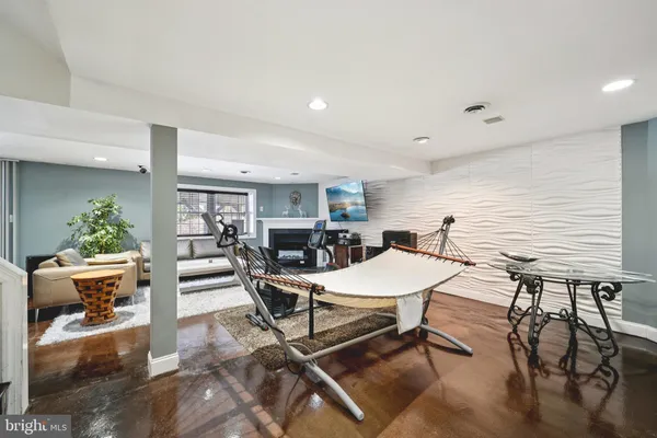 a view of a dining room with furniture wooden floor and a potted plant
