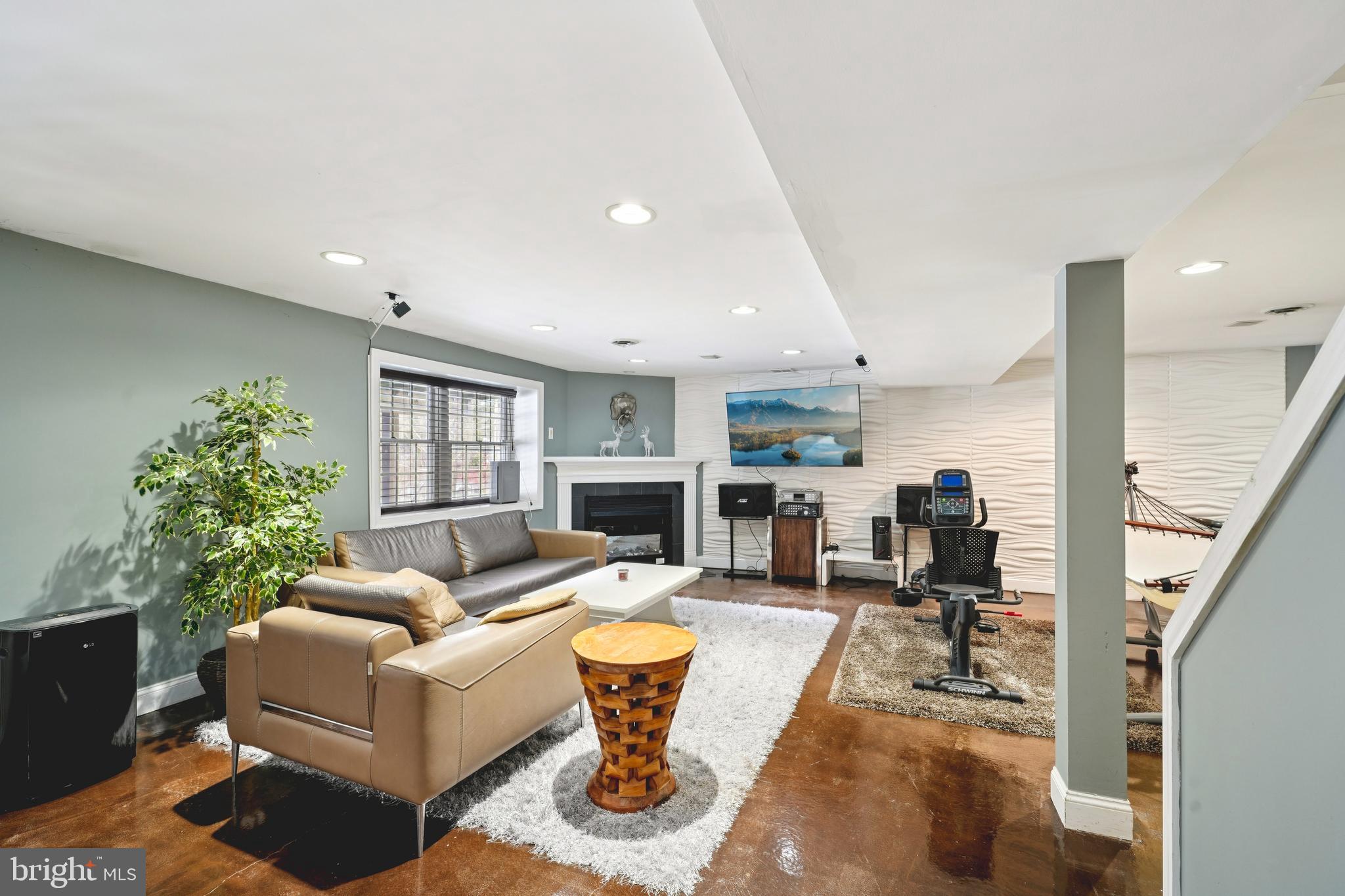 700 Campwoods Road Villanova, PA 19085 - Photo 41 of 72 a living room with fireplace furniture and a potted plant