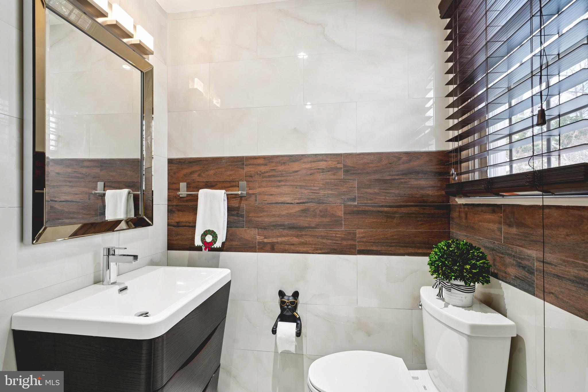 700 Campwoods Road Villanova, PA 19085 - Photo 47 of 72 a bathroom with a toilet sink and mirror