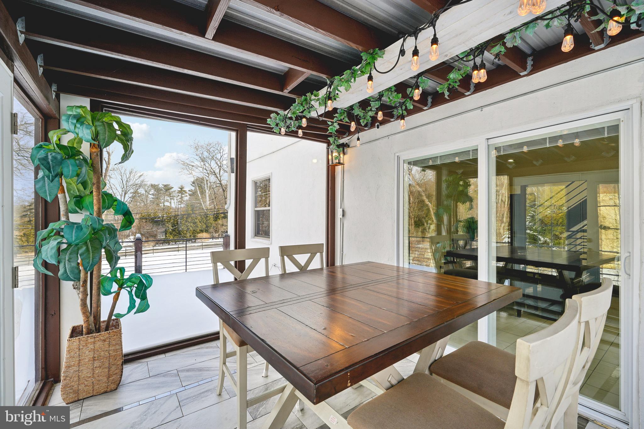 700 Campwoods Road Villanova, PA 19085 - Photo 51 of 72 a dining room with furniture wooden floor and a potted plant