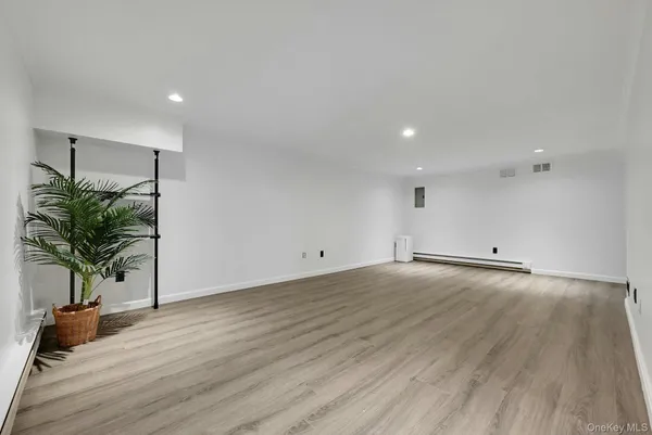 a view of a room and wooden floor
