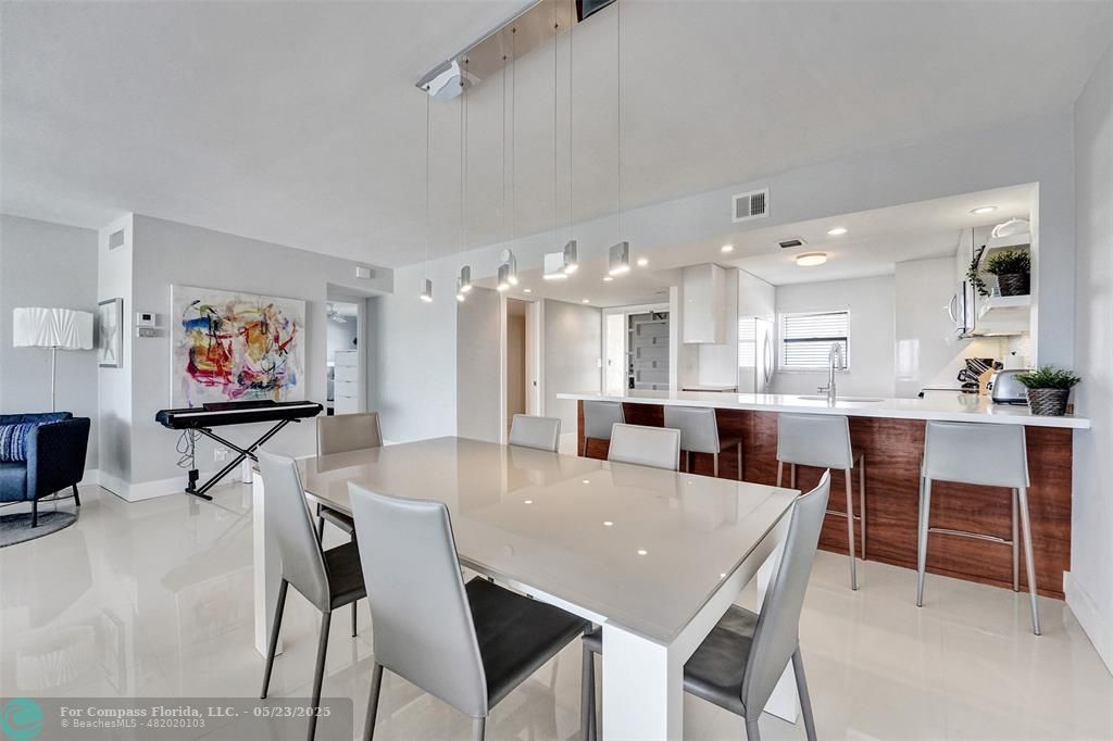 1523 East Hillsboro Boulevard, Unit 1031 Deerfield Beach, FL 33441 - Photo 11 of 78 Easily sit 4 at the countertop seating and 6 at the dining table in this condo!