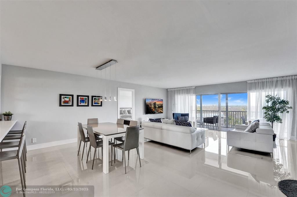 1523 East Hillsboro Boulevard, Unit 1031 Deerfield Beach, FL 33441 - Photo 12 of 78 a living room with furniture a computer on the desk and kitchen view