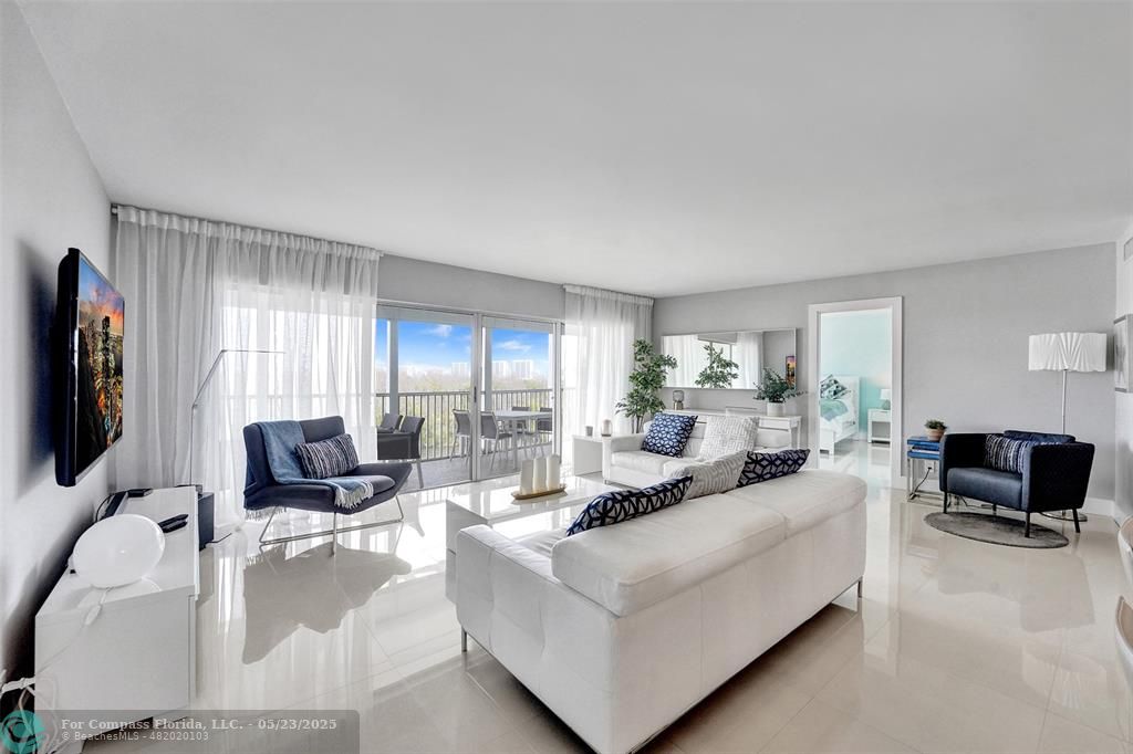 1523 East Hillsboro Boulevard, Unit 1031 Deerfield Beach, FL 33441 - Photo 18 of 78 a living room with furniture and a flat screen tv
