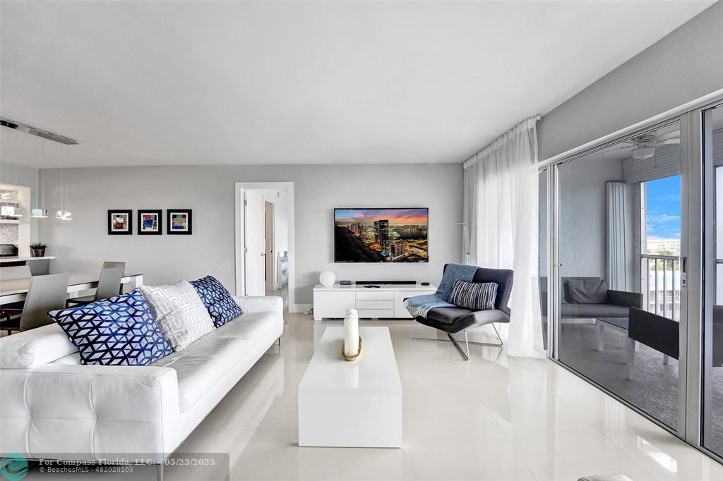 1523 East Hillsboro Boulevard, Unit 1031 Deerfield Beach, FL 33441 - Photo 26 of 78 a living room with furniture and a flat screen tv